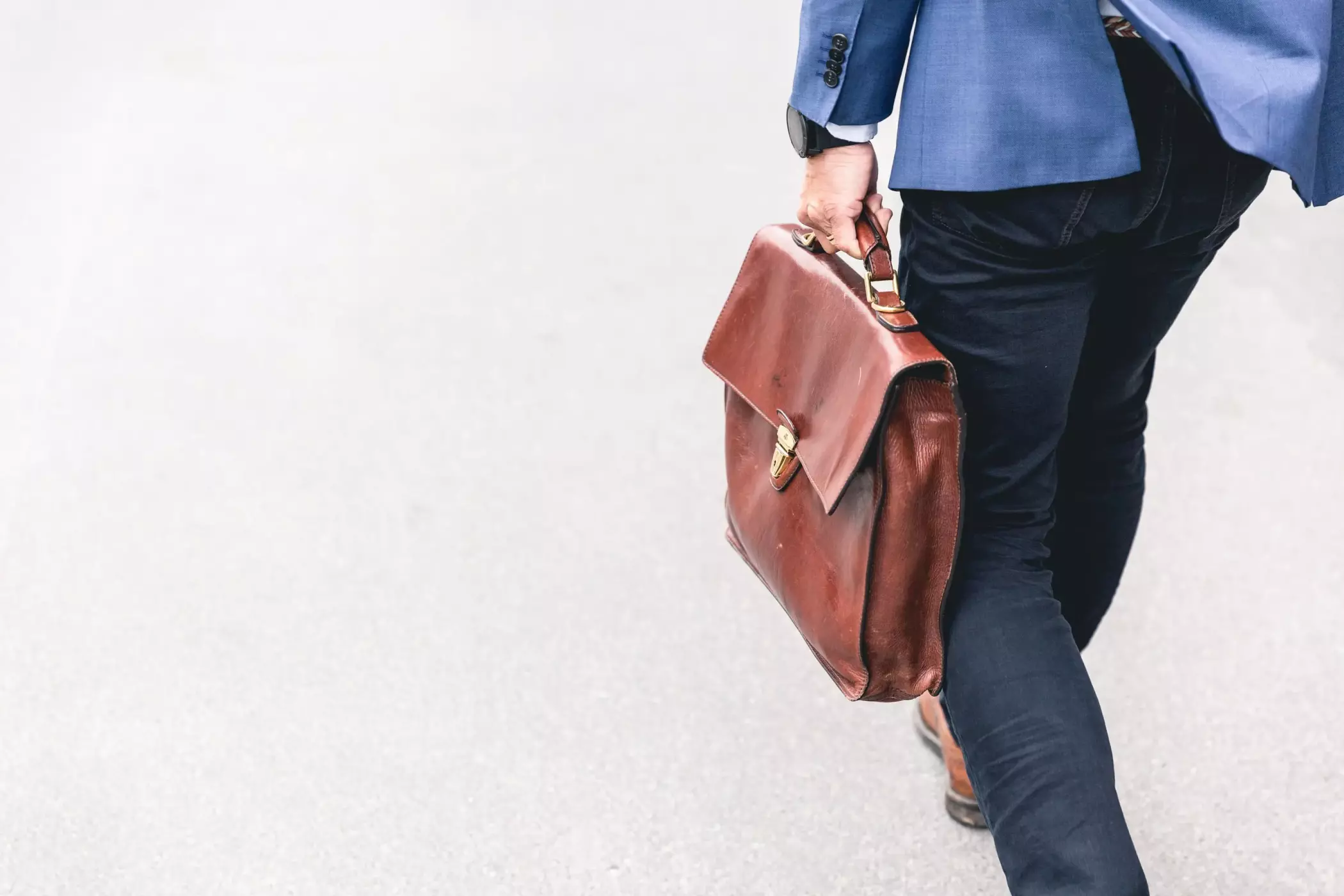 Men walking with a suitcase.